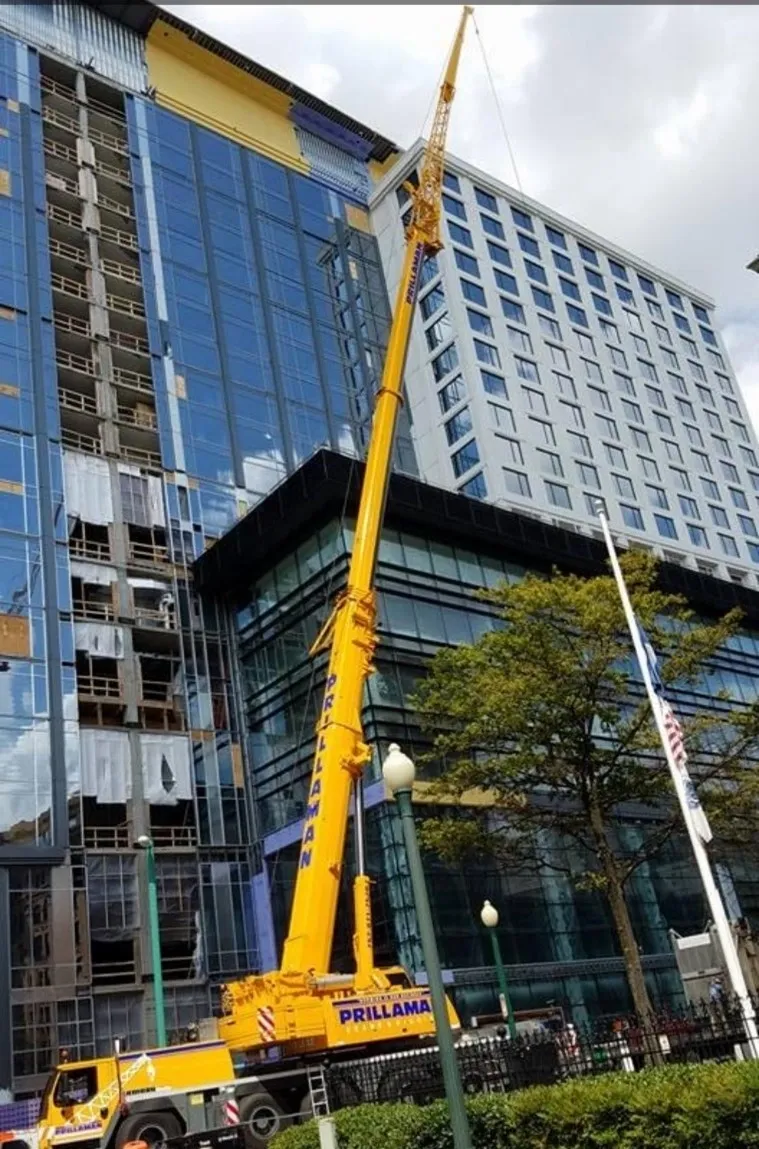 A crane is in front of some buildings