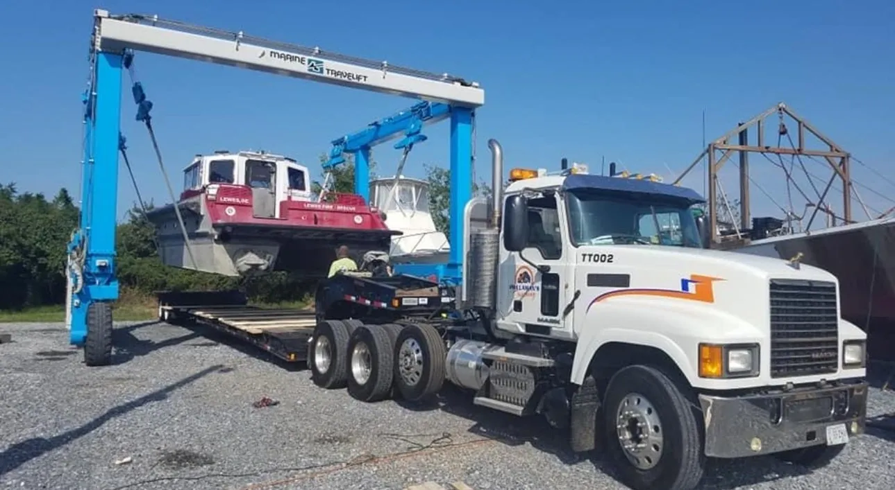 A tow truck is towing a car on the back of it.