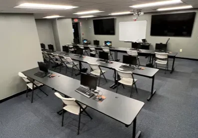 A classroom with many tables and chairs